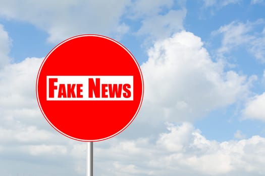 No entry for fake news prohibitory traffic sign against blue sky and white clouds