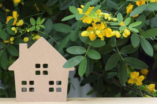 wooden toy house with beautiful blossom tree in background
