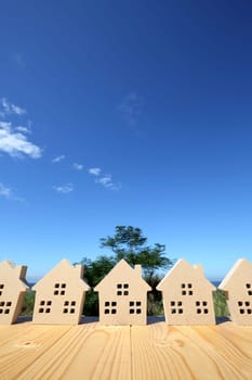Miniature model of house with blue sea and sky background