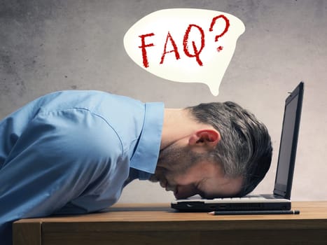 Handsome business man sleeping on a laptop, help or FAQ concept image