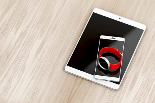 Tablet, smartphone and smartwatch on wood background