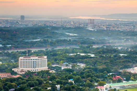 Mandalay with lake mountains, temples and pagodas seen from mandalay hill at sunset, Burma.