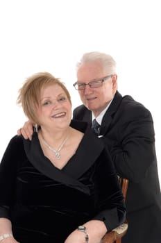 A beautiful senior citizen couple standing and embracing each other in.suits, isolated for white background..