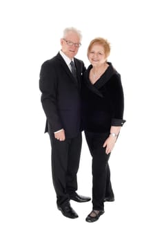 A lovely older couple standing in suits, holding each other in full .lengths, isolated for white background..