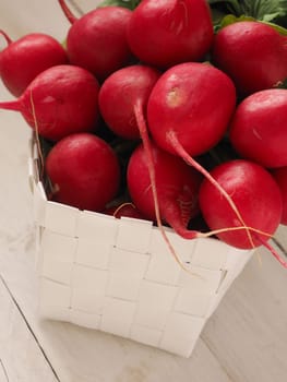 Bunch of organic radishes on an old wooden table, healthy food concept