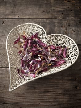 Heart shape of tulip leaves on a rustic wooden table