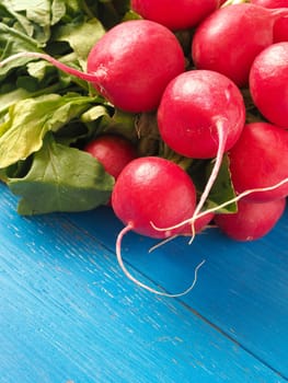 Bunch of organic radishes on an old wooden table, healthy food concept