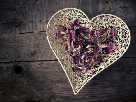 Heart shape of tulip leaves on a rustic wooden table
