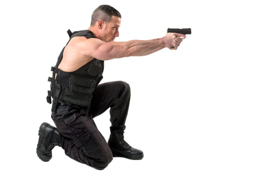 Man with tactical vest and gun isolated in white