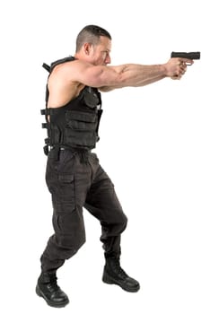 Man with tactical vest and gun isolated in white