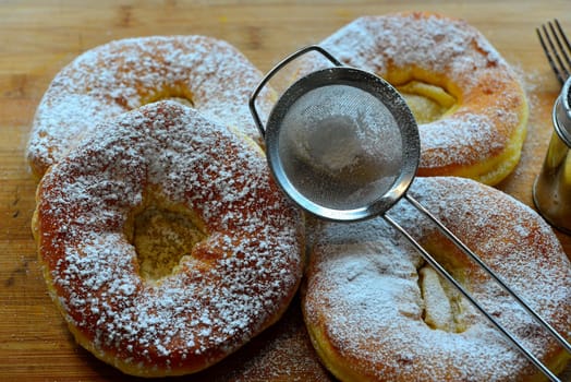 Photo freshly baked pulled out Küchle doughnuts with icing sugar