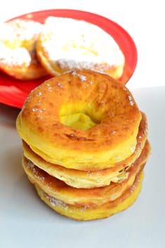 Photo freshly baked pulled out Küchle doughnuts with icing sugar