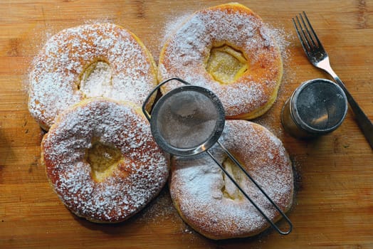 Photo freshly baked pulled out Küchle doughnuts with icing sugar