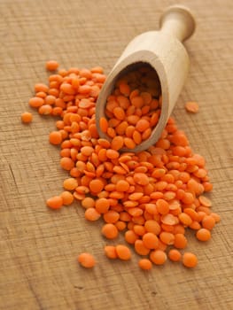 Organic red lentils on a wooden table