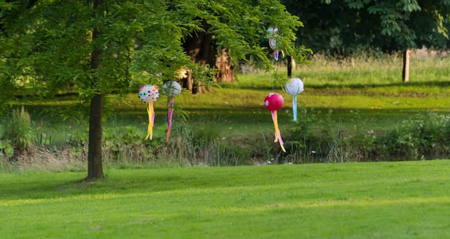 lampions hanging on a tree in a park