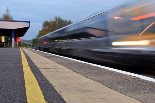 Blurred fast train during departure from the station.