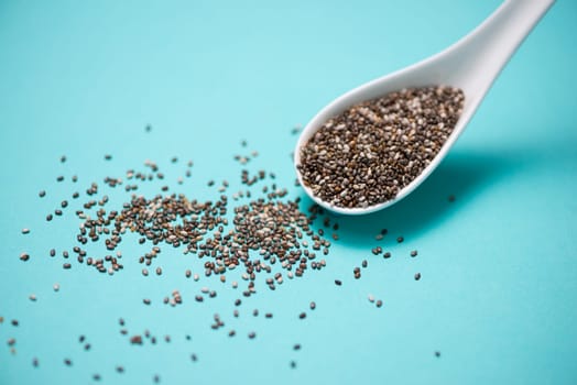 Close-up of ealthy chia seeds in a spoon. Text space.