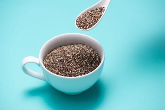 Close-up of ealthy chia seeds in a spoon. Text space.