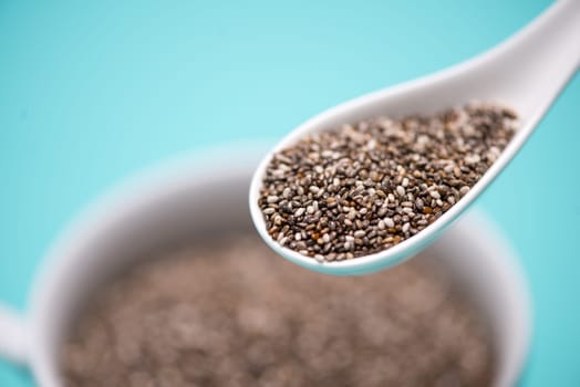 Close-up of ealthy chia seeds in a spoon. Text space.