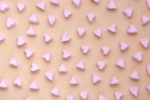 Valentines Day candy hearts marshmallows over green background
