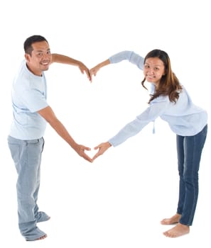 Asian couple making heart shape with hands