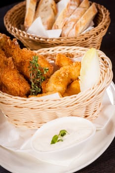 Crispy fried chicken wings with a dip on a plate