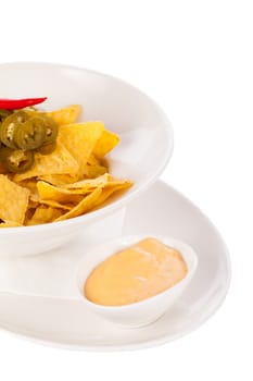 Bowl with nachos tortillas with pepperoni and fresh tomato salsa in a plate insulated against a white background