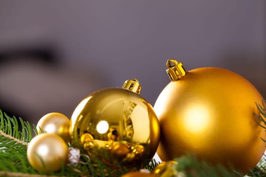 Golden shiny Christmas tree decoration Advebtsschmuck on green fir branches as close-up