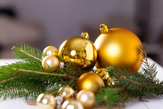 Golden shiny Christmas tree decoration Advebtsschmuck on green fir branches as close-up