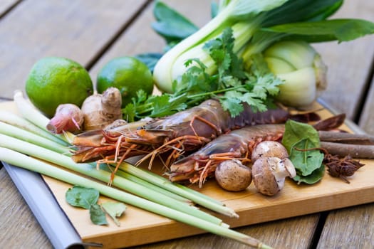 Ingredients for Tom Yam soup with lemongrass shrimp coriander on a kitchen board