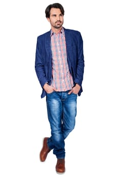Young man in trendy casual look with dark hair and beard isolated against a white background