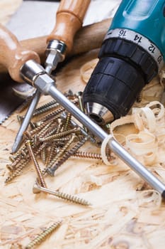 DO-it-yourself tool with cordless screwdriver,screwdriver,saw and screws in a workshop