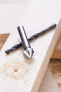 Cordless screwdriver in a carpentry shop with drill and sinker as a detailed recording for do-it-yourselfers