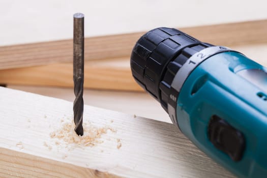 Cordless screwdriver in a carpentry shop with drill and sinker as a detailed recording for do-it-yourselfers