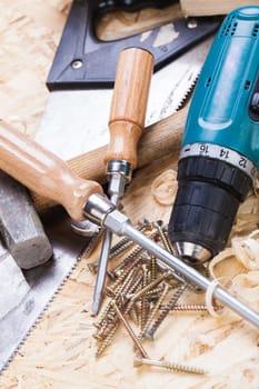 DO-it-yourself tool with cordless screwdriver,screwdriver,saw and screws in a workshop