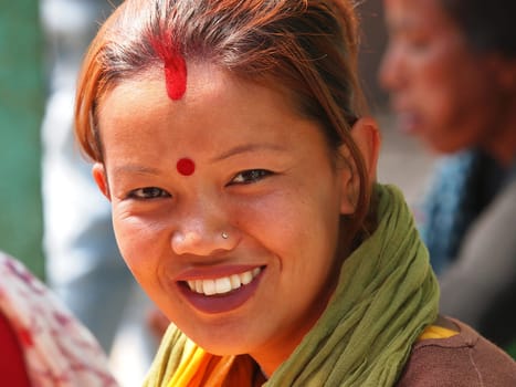 young girl from Nepal with red hear