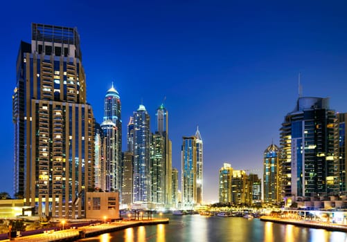 skyline of Dubai Marina at night with boats, United Arab Emirates, Middle East