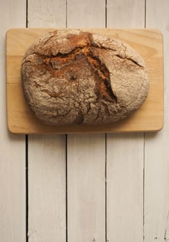 Tasty bread on a rustic wooden background with space for text, view from above