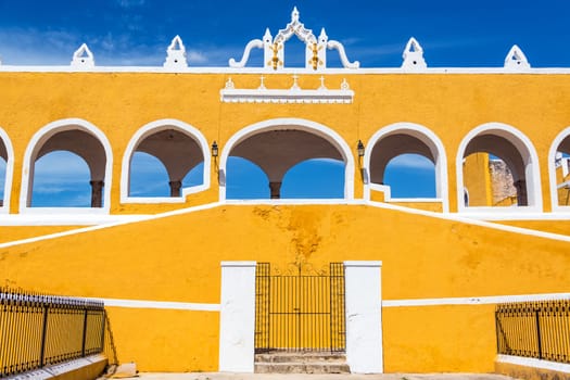 Exterior of the beautiful yellow monastery in Izamal, Mexico with a stunning blue sky