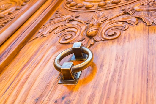 Metal door handle of old wooden vintage door
