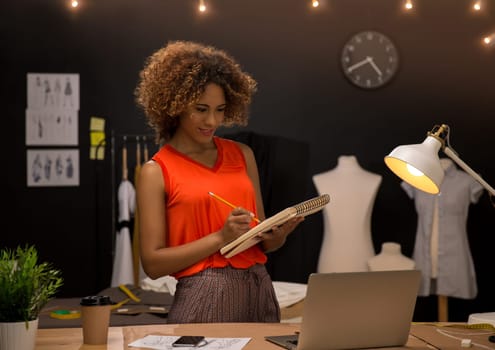 A young fashion designer working on her atelier
