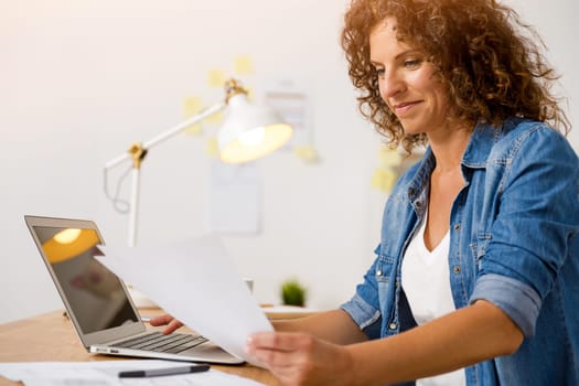 Middle age woman working at the office