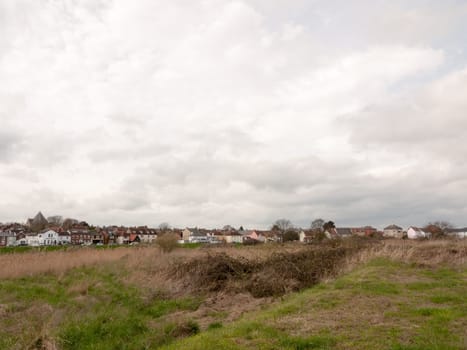 A field with houses in the far distance