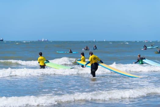 SCHEVENINGEN, NETHERLANDS - JULY 3, 2016: Surf school students in action on the dutch North Sea coast