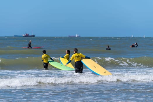 SCHEVENINGEN, NETHERLANDS - JULY 3, 2016: Surf school students in action on the dutch North Sea coast