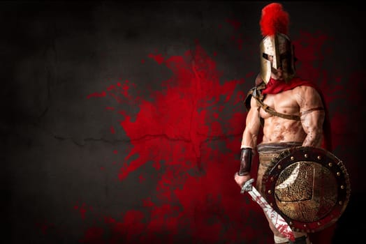 Ancient warrior or Gladiator posing over a dark background