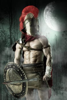 Ancient warrior or Gladiator posing in a dark forest