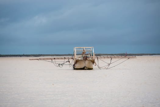 Fishing boat moving through the river on cloudy day