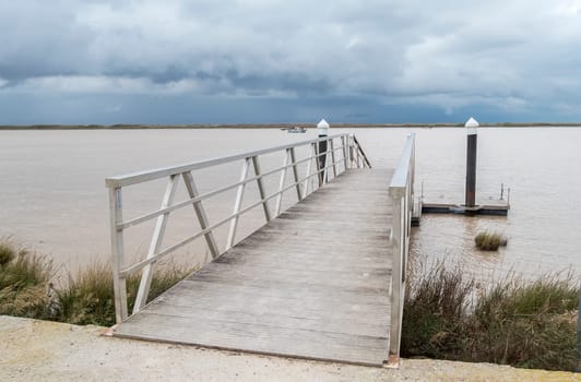 Wooden pier river on a cloudy day