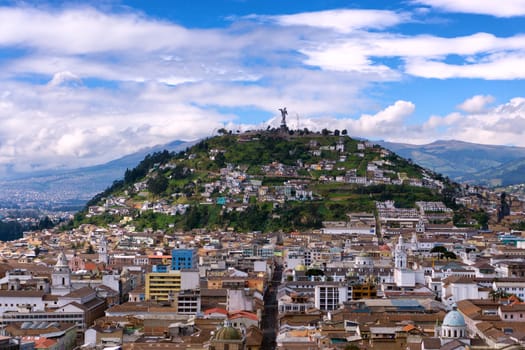 View of the historic center of Quito, Ecuador as with Panecillo hill rising in the background